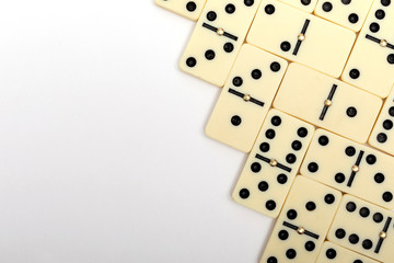 Parts of game of domino on white background with copy space for text.