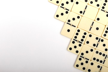 Parts of game of domino on white background with copy space for text.