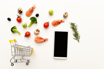 Shopping cart with fresh products and phone  © Svetlana Sotnikova