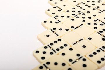 Parts of game of domino on white background with copy space for text.