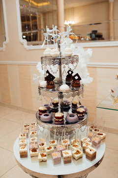 Cute candy bar with various candies and cakes. Wedding sweets. wedding decorations: cake, muffins. Birthday party. Celebration.