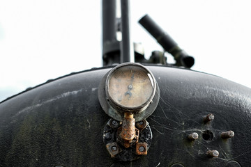 Close-up of a vintage steam pressure gauge located on the boiler of a very old steam traction...
