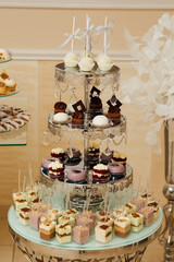 Luxury candy bar with pastries, cakes and other sweets, as decoration and entertainment for the holiday guests. Buffet with a variety of delicious sweets, food ideas, celebration.  