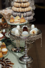 Luxury candy bar with pastries, cakes and other sweets, as decoration and entertainment for the holiday guests. Buffet with a variety of delicious sweets, food ideas, celebration.  