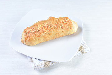 Fine bread with cheese on white wooden background