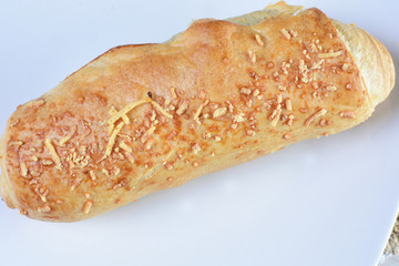 Fine bread with cheese on white wooden background