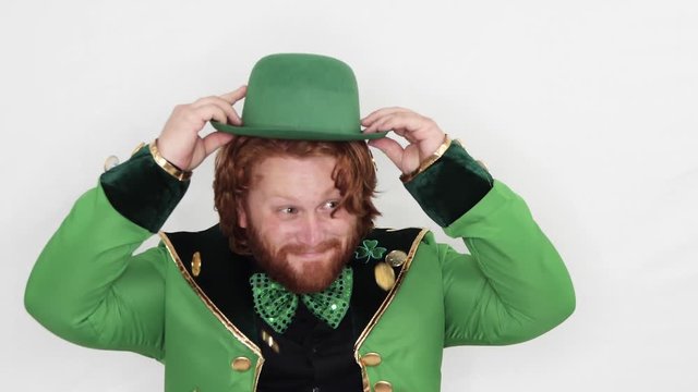 Red Headed Man putting on hat full of Gold Coins St. Patricks Day Celebration, Studio Static