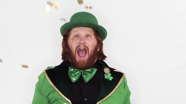 Red Headed Man throwing gold coins in air celebrating St Patricks Day, static, slow motion