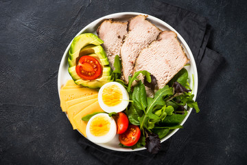 Keto diet plate on black stone table.