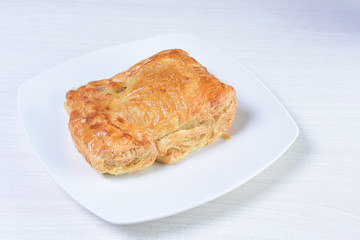 Chicken pie on white wooden background