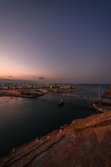 Boat crossing the suspension bridge during at Sur's bay, Oman