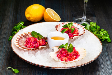 Ceviche. Finely chopped raw tuna and salmon marinated in lemon juice served in seashell.