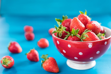 strawberries in a colorful bowl on a colorful background