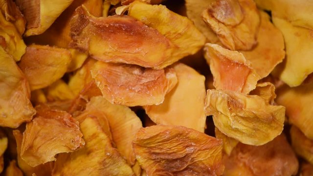 Dried mango rotation. Dried fruits background. Fresh sweet dates, organic food. Food ingredient background. Vegan, vegetarian diet. Healthy lifestyle.