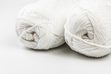 woolen white threads on white  background. natural wool. knitting. background