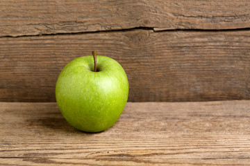 Green apple on a wooden background