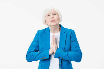 Senior grey-haired woman begging standing over isolated white background