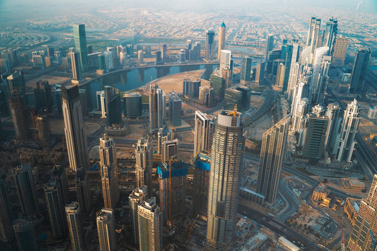 Dubai skyline with skyscrapers in downtown aerial view from above. Morning in futuristic luxury city with many high buildings.