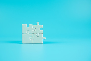 Jigsaw puzzle pieces on blue background with copy space for text. solutions, mission, successful, goals, cooperation, partnership and strategy concept