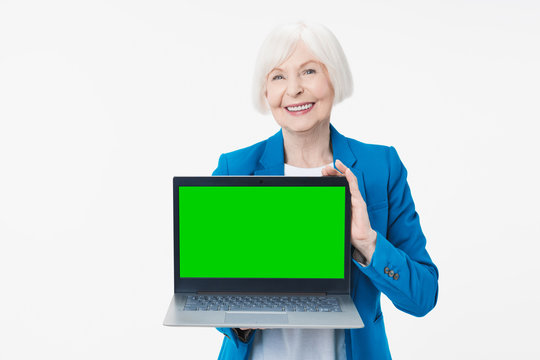 Cheerful Mature Woman Showing Chroma Key Screen Laptop Computer Isolated Over White Background