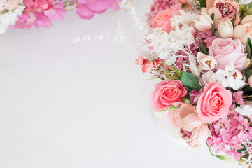 Obraz na płótnie Canvas Feminine floral frame composition. Decorative web banner made of beautiful pink peonies. White background. Empty space. Flat lay, top view. Picture for blog