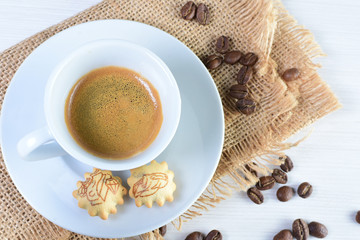Cup of hot coffee white wooden background