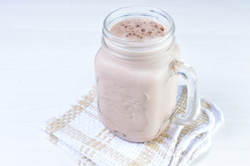 Cold base with refreshing chocolate drink on white wooden background