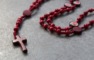 Red rosary on a stone background