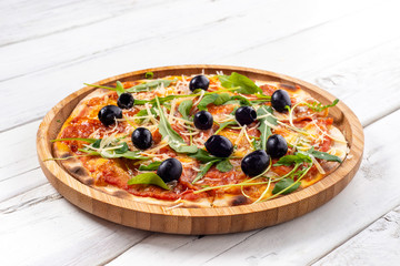Italian pepperoni pizza on white wooden background
