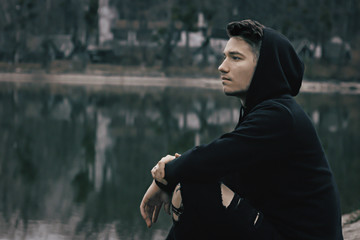 a guy relaxing in forest at day