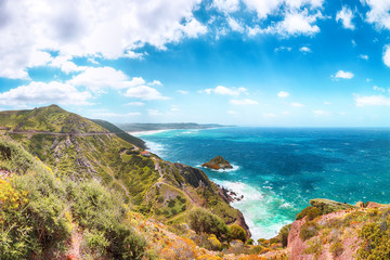 Astonishing spring view of Nebida and Fontanamare coastline with Scoglio il Morto and turquoise sea