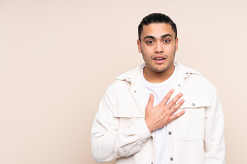 Asian handsome man over isolated background surprised and shocked while looking right