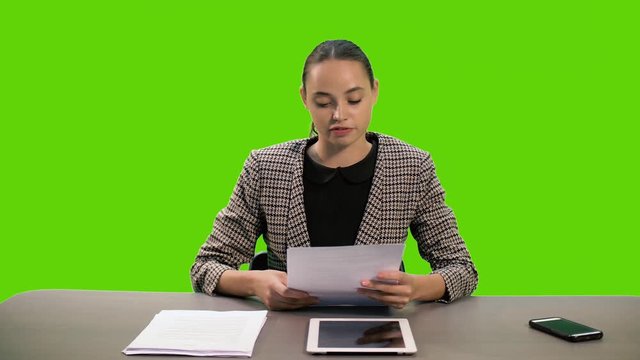 A female newsreader presenting the news, add your own text or image screen behind her on a Green Screen, Chroma Key.