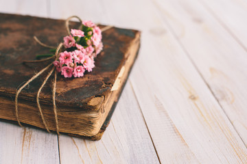 Vintage books with bouquet of flowers/ nostalgic vintage background