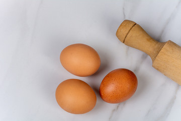 Close-up of eggs and rolling pin.