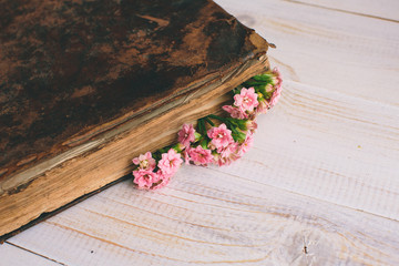 Vintage books with bouquet of flowers/ nostalgic vintage background