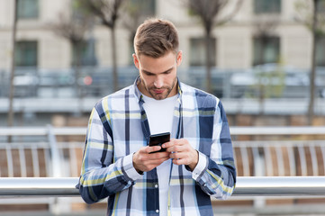 Sharing location options. Application. Man hold smartphone buildings background. Messaging online....