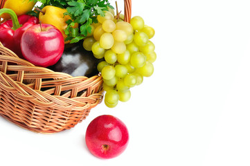 Vegetables and fruits in a basket isolated on white background. Free space for text.