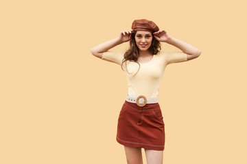 Young beautiful girl dressed in retro vintage style in the old european city