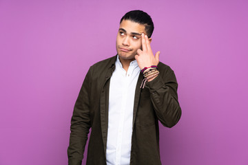 Asian handsome man isolated on blue background with problems making suicide gesture