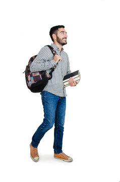 Full length picture of a young excited male student walking  with a smile on his face. Isolated on white background 