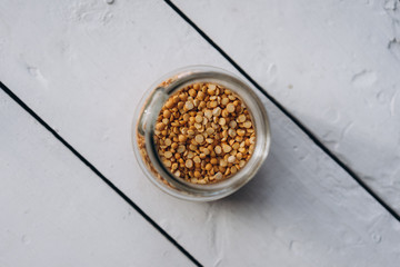 cereal peas in a glass jar close-up on a white wooden background