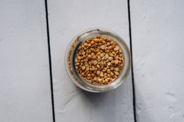 cereal peas in a glass jar close-up on a white wooden background