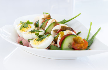 healthy and balanced meal of egg salad with bocconccini and cucumber
