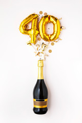 Happy 40th anniversary party. Champagne bottle with gold number balloon.