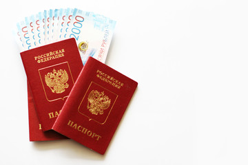Russian foreign passport with russian money on a white background. Dark red passport cover with copy space