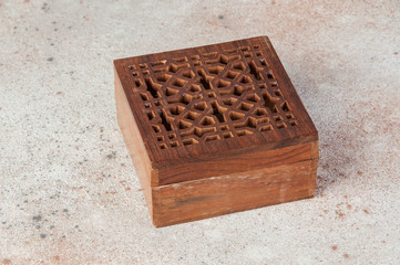 Vintage wooden aroma box on concrete background.