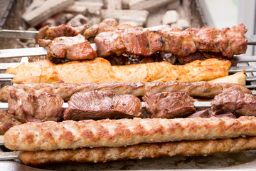 Various meat dishes cooked on the grill (over an open fire) using skewers