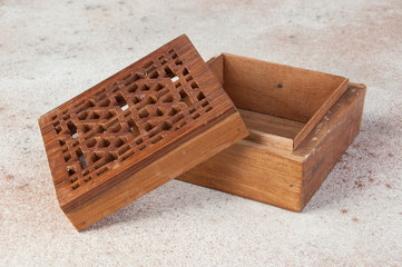 Vintage wooden aroma box on concrete background.
