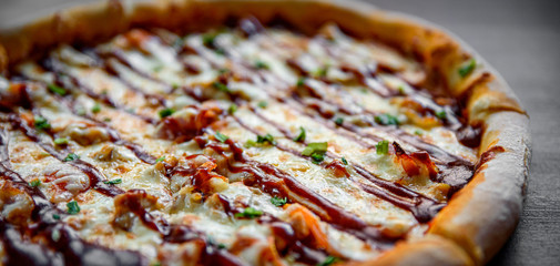 Pizza with chicken and barbeque sauce . Italian pizza on wooden table background